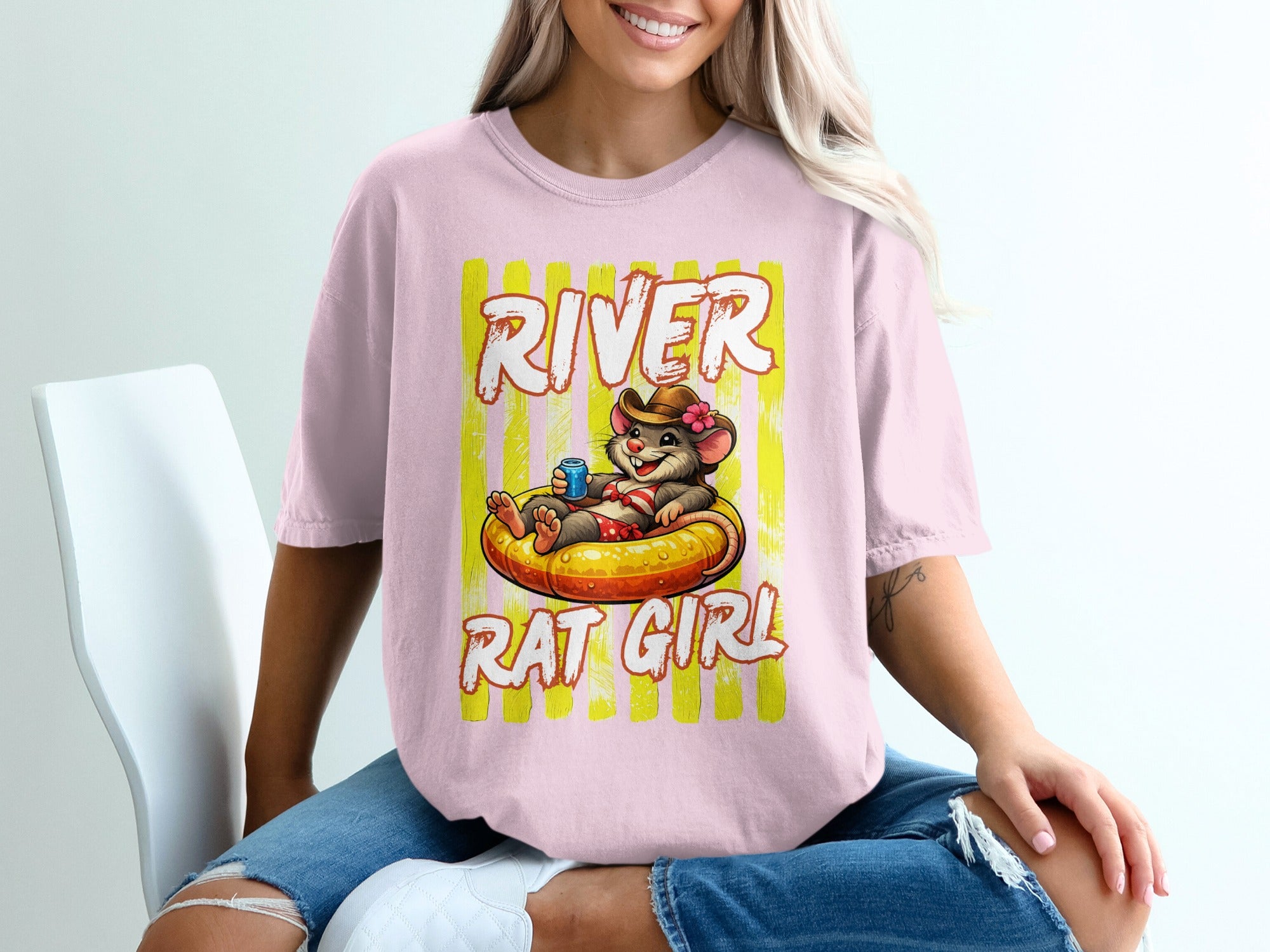 Shirt graphic: a rat in a cowboy hat floats in an inner tube, text reads "River Rat Girl."