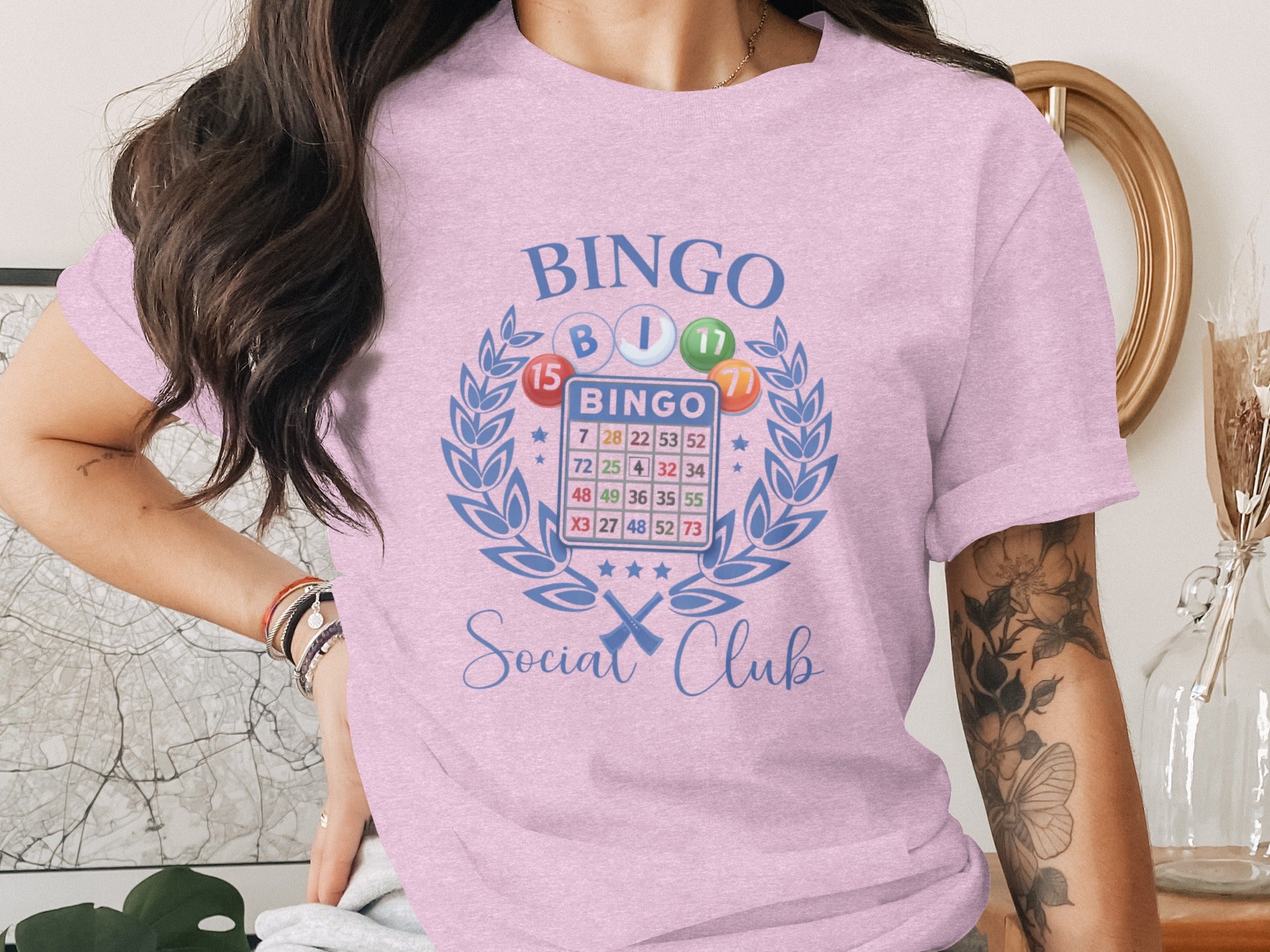 Pink t-shirt with "Bingo Social Club" text and bingo card graphic.