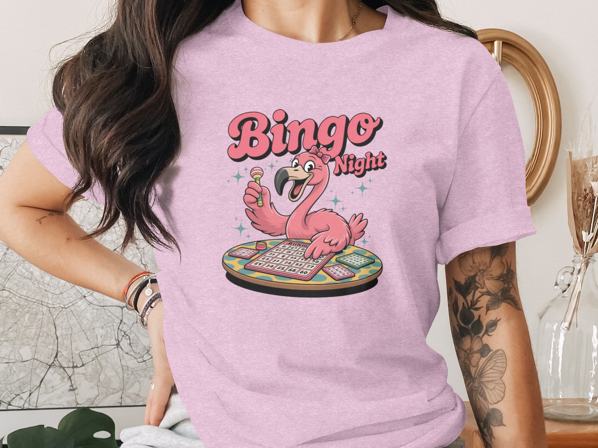Pink t-shirt with cartoon flamingo playing bingo, text "Bingo Night".