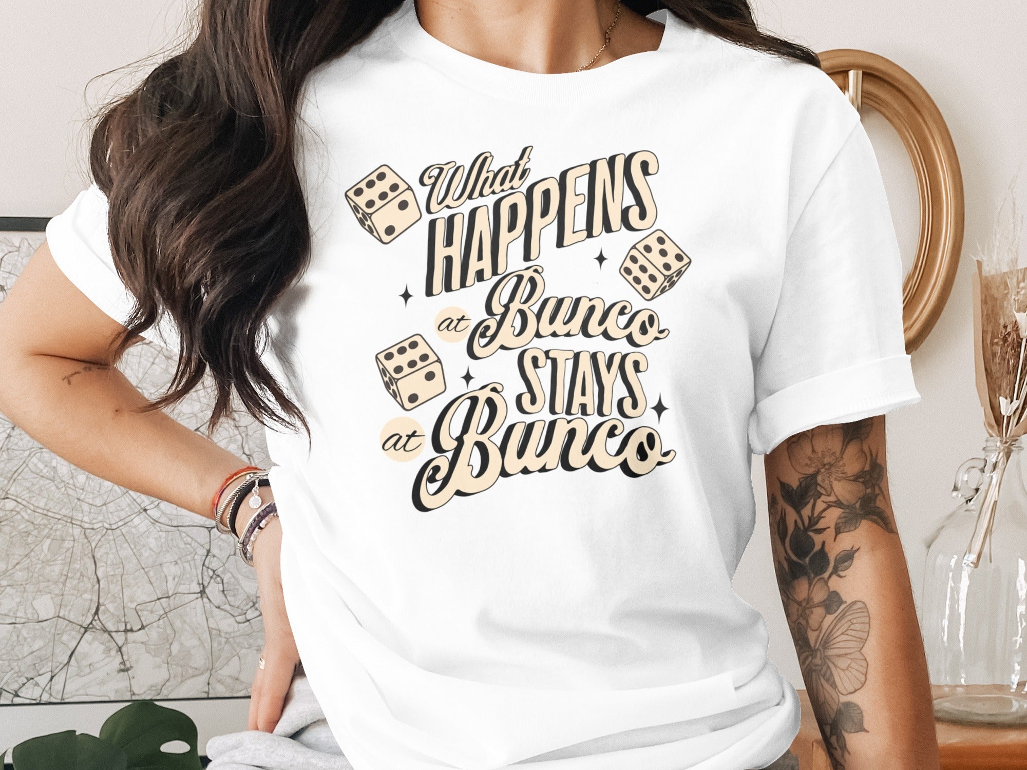 White t-shirt with "What HAPPENS at Bunco STAYS at Bunco" text and dice graphics.
