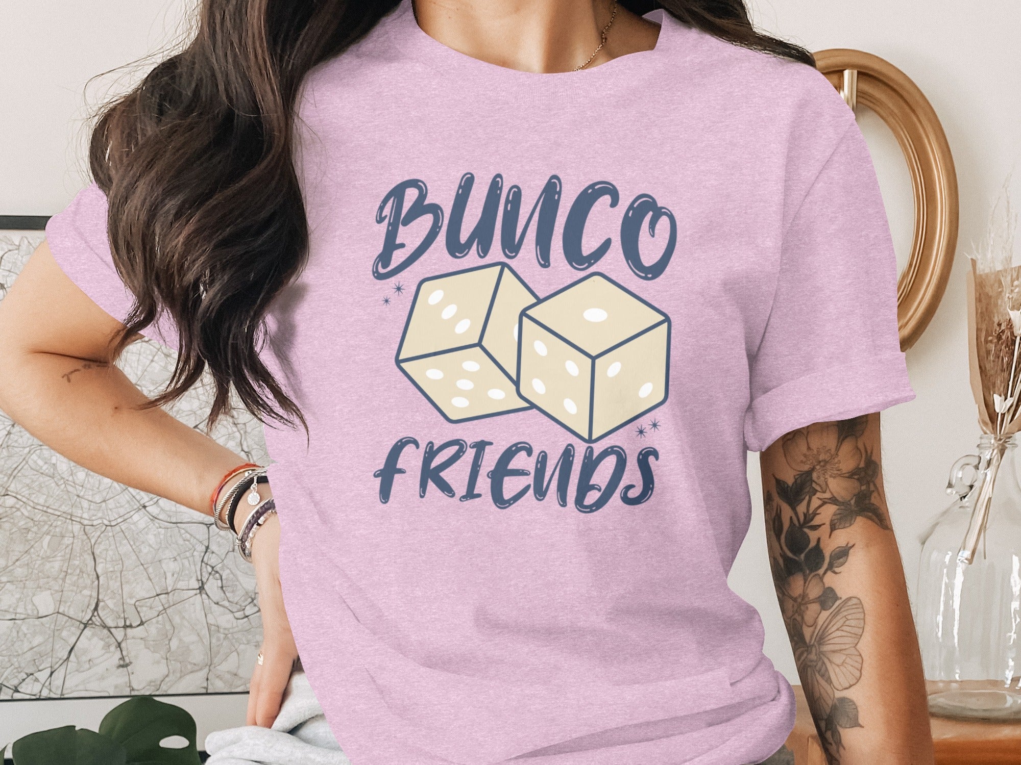 Bunco Friends text with two dice graphic on a pink t-shirt.