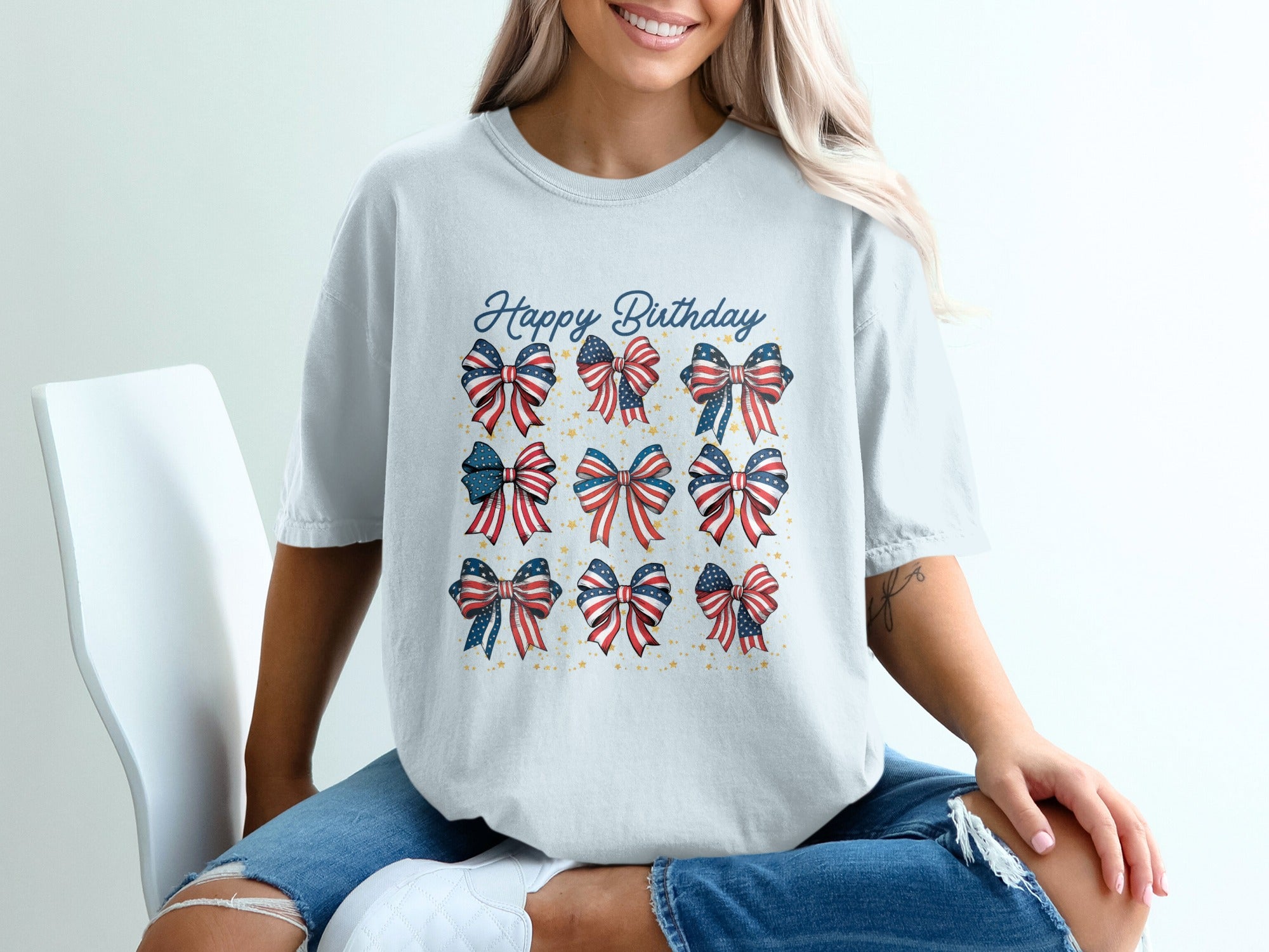 White t-shirt with red, white, and blue patriotic bows and "Happy Birthday" text.