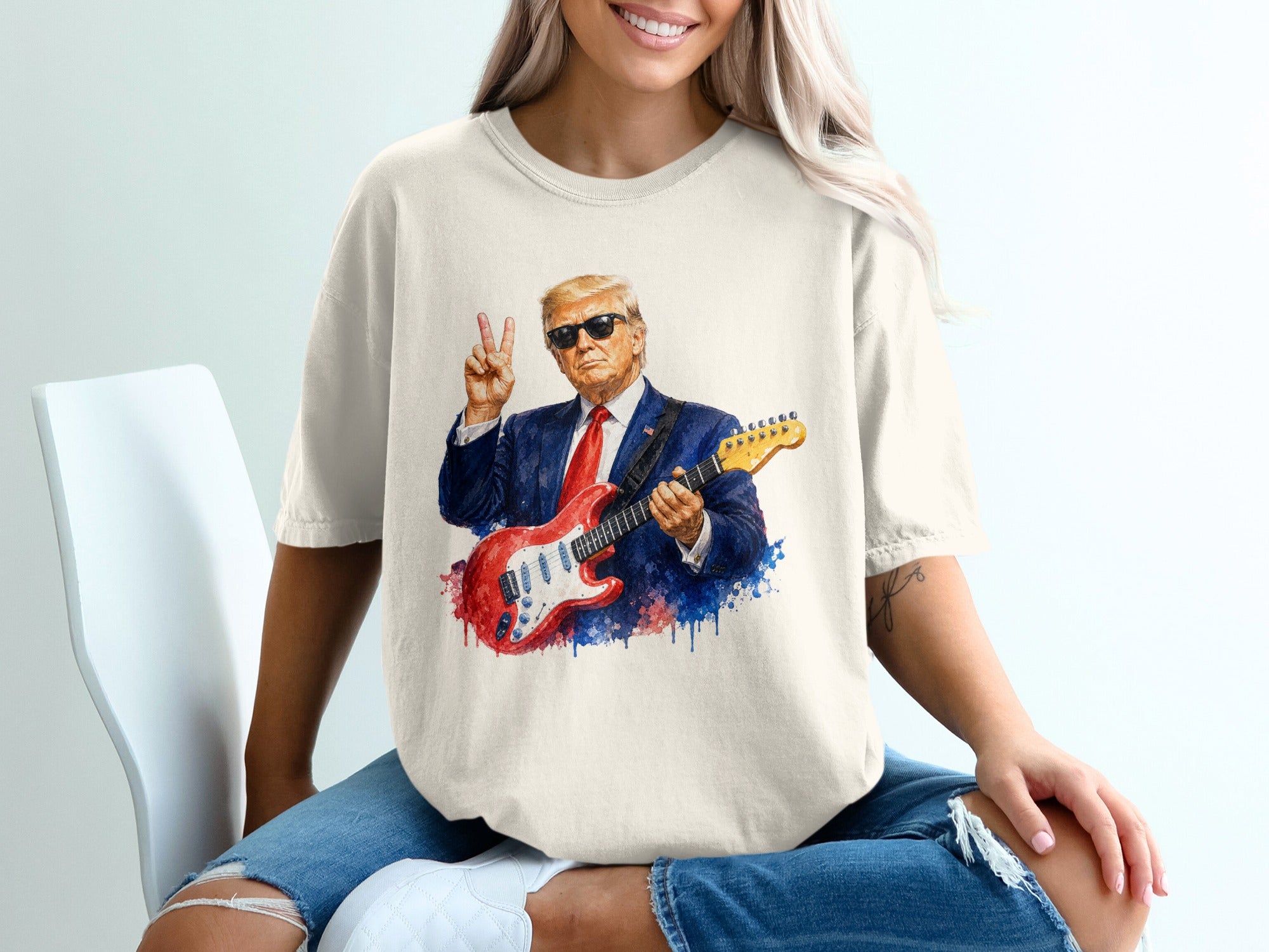 Donald Trump wearing sunglasses and playing a red electric guitar, giving a peace sign.