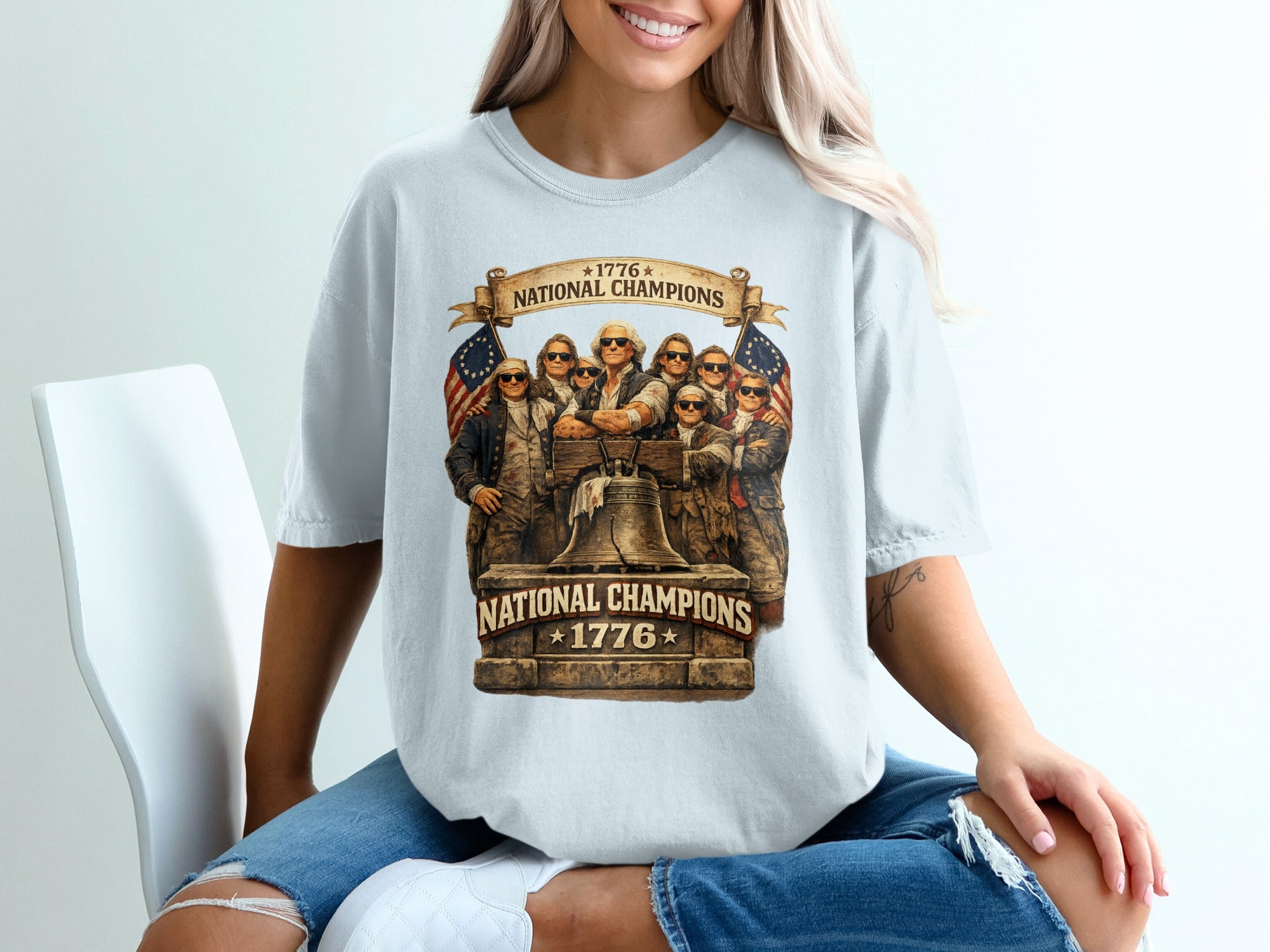 T-shirt graphic with Liberty Bell, flags, and "1776 National Champions" text.