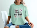 Light blue t-shirt with text "most likely to day drink" and cocktail graphics.