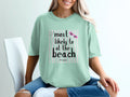 Mint t-shirt with "most likely to at the beach" text and pink sunglasses graphic.