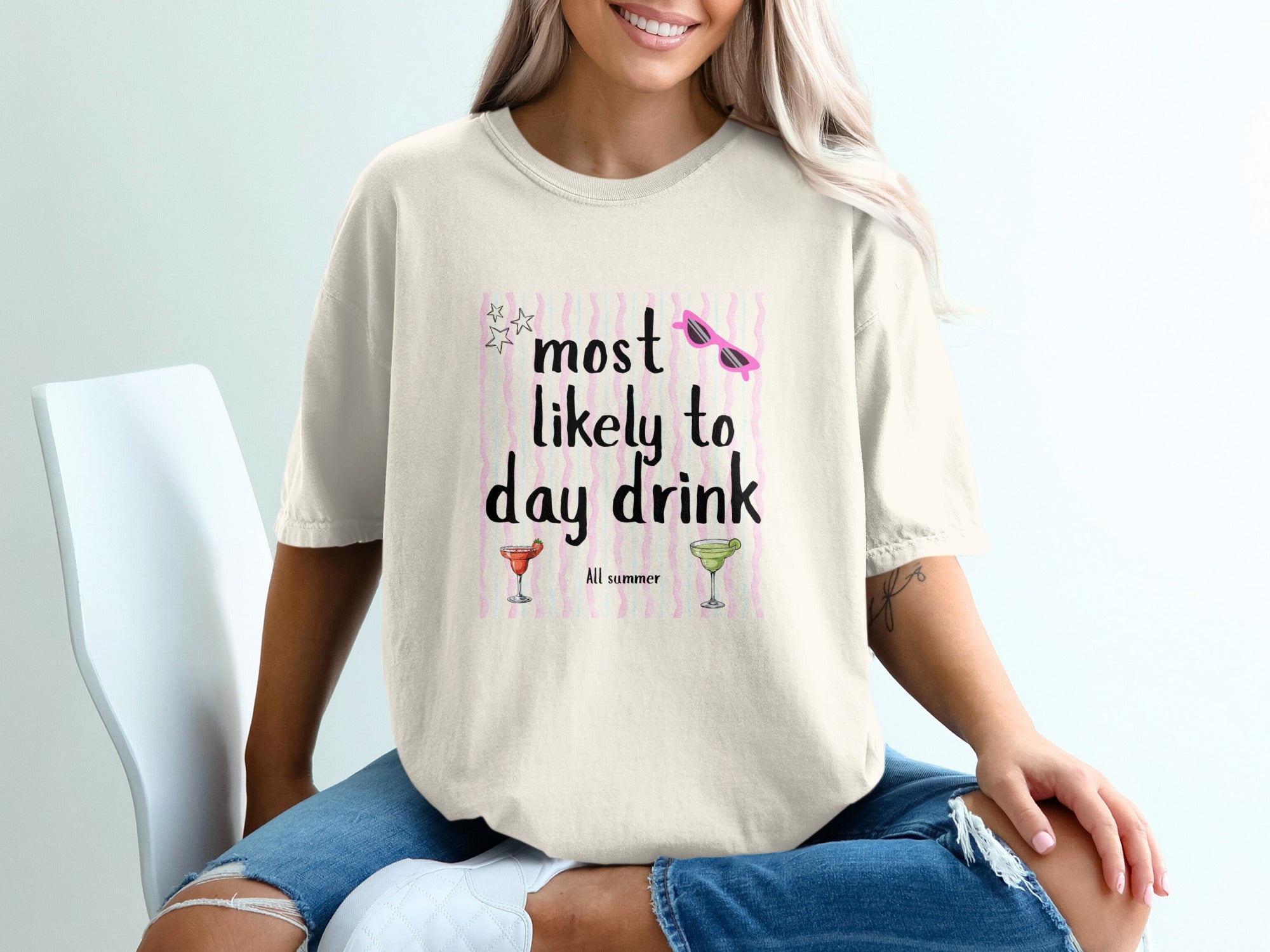 Cream t-shirt with "most likely to day drink all summer" graphic.