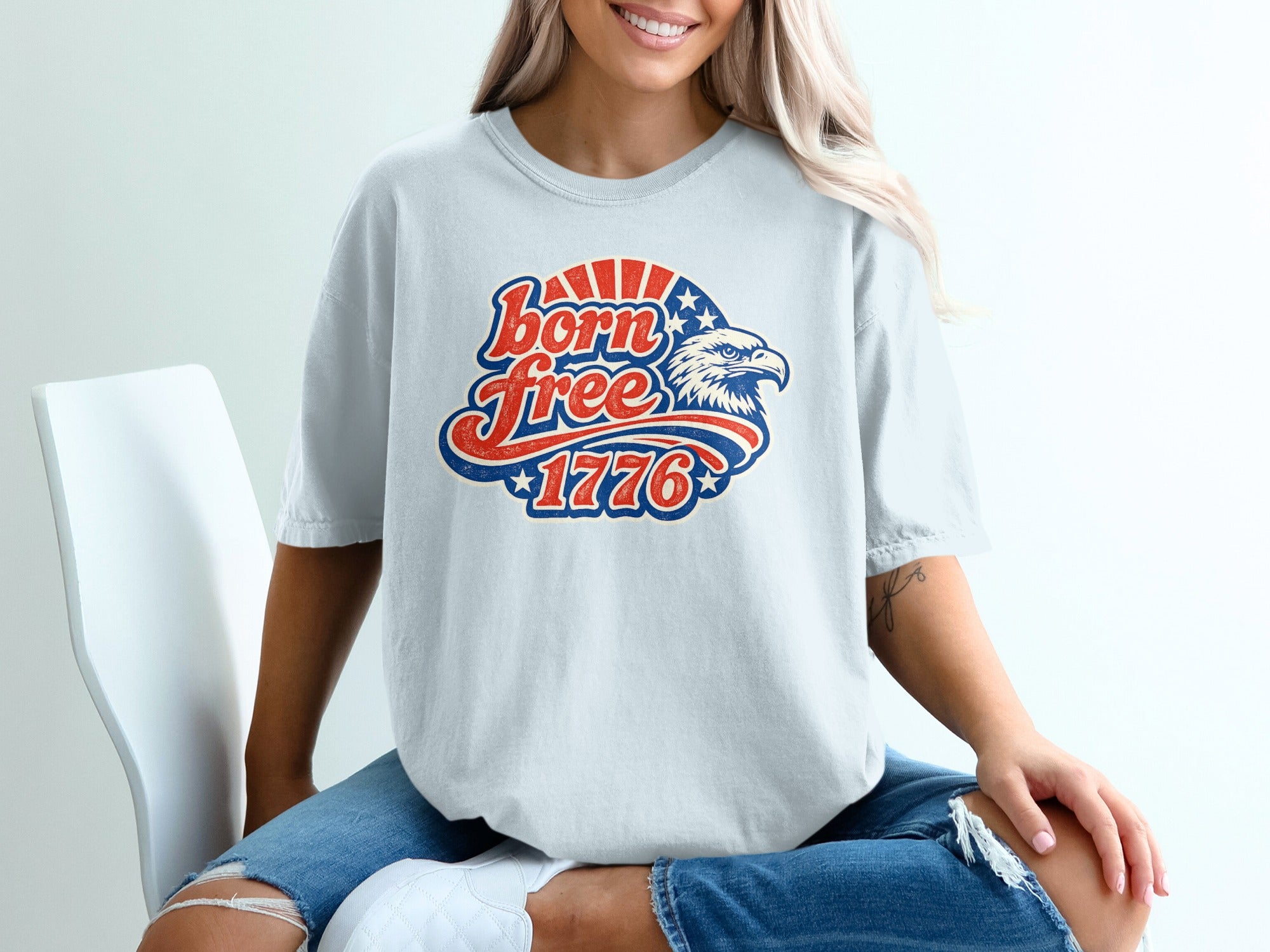 White t-shirt with "Born Free 1776" and eagle graphic.