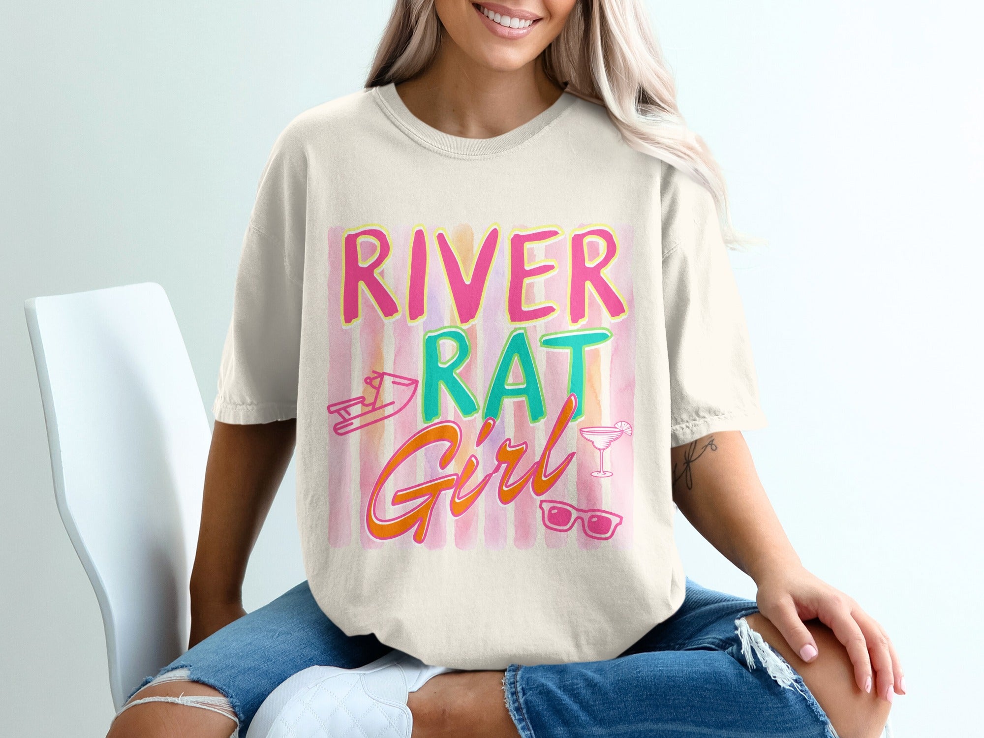 Cream t-shirt with "River Rat Girl" text and summery graphics.