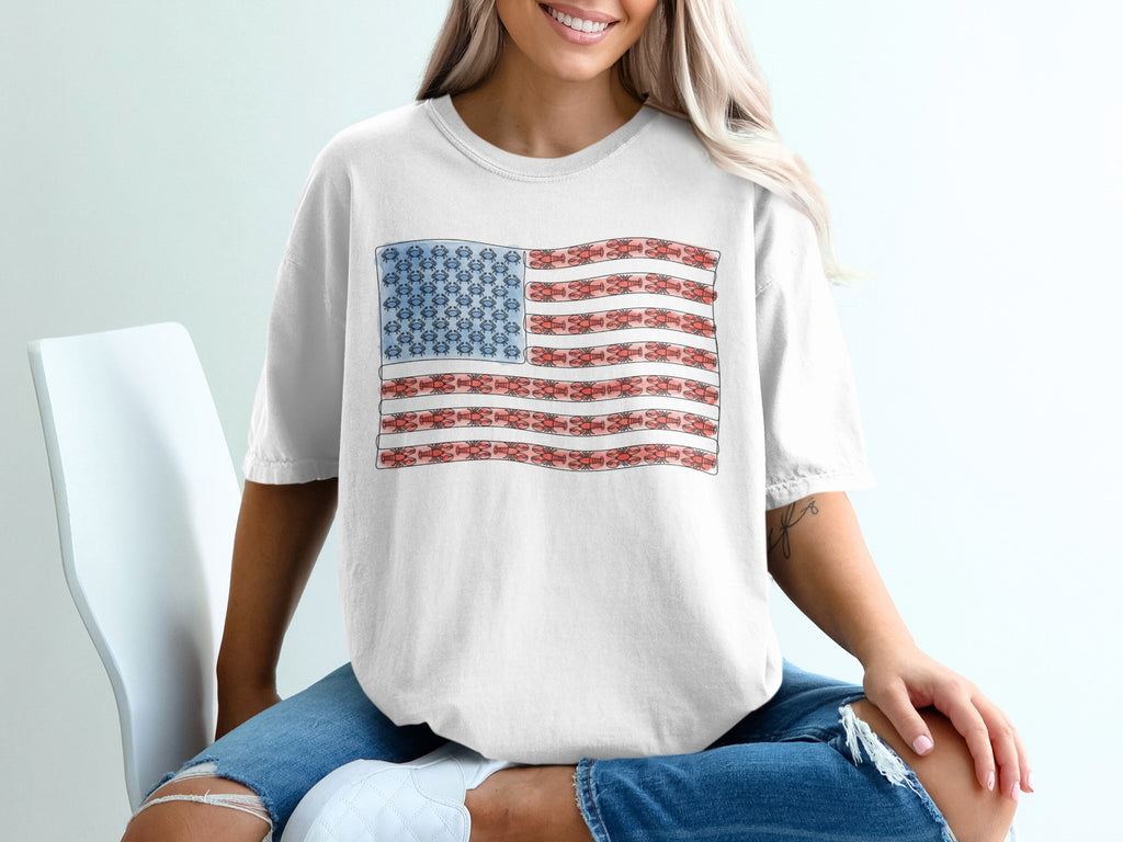White t-shirt with an American flag design made of cartoonish molecules.