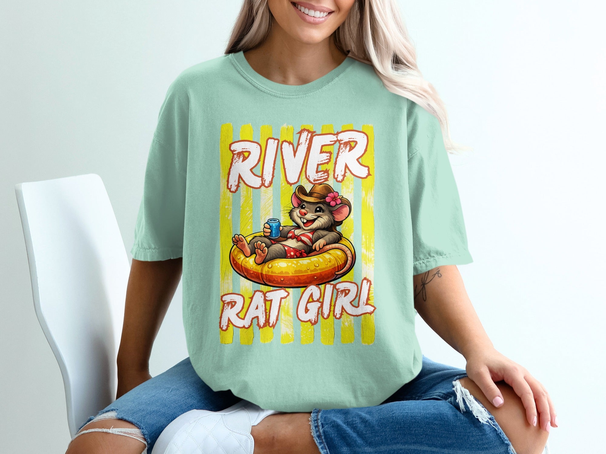 Mint t-shirt with illustration of a rat wearing sunglasses in an inner tube, text "River Rat Girl."