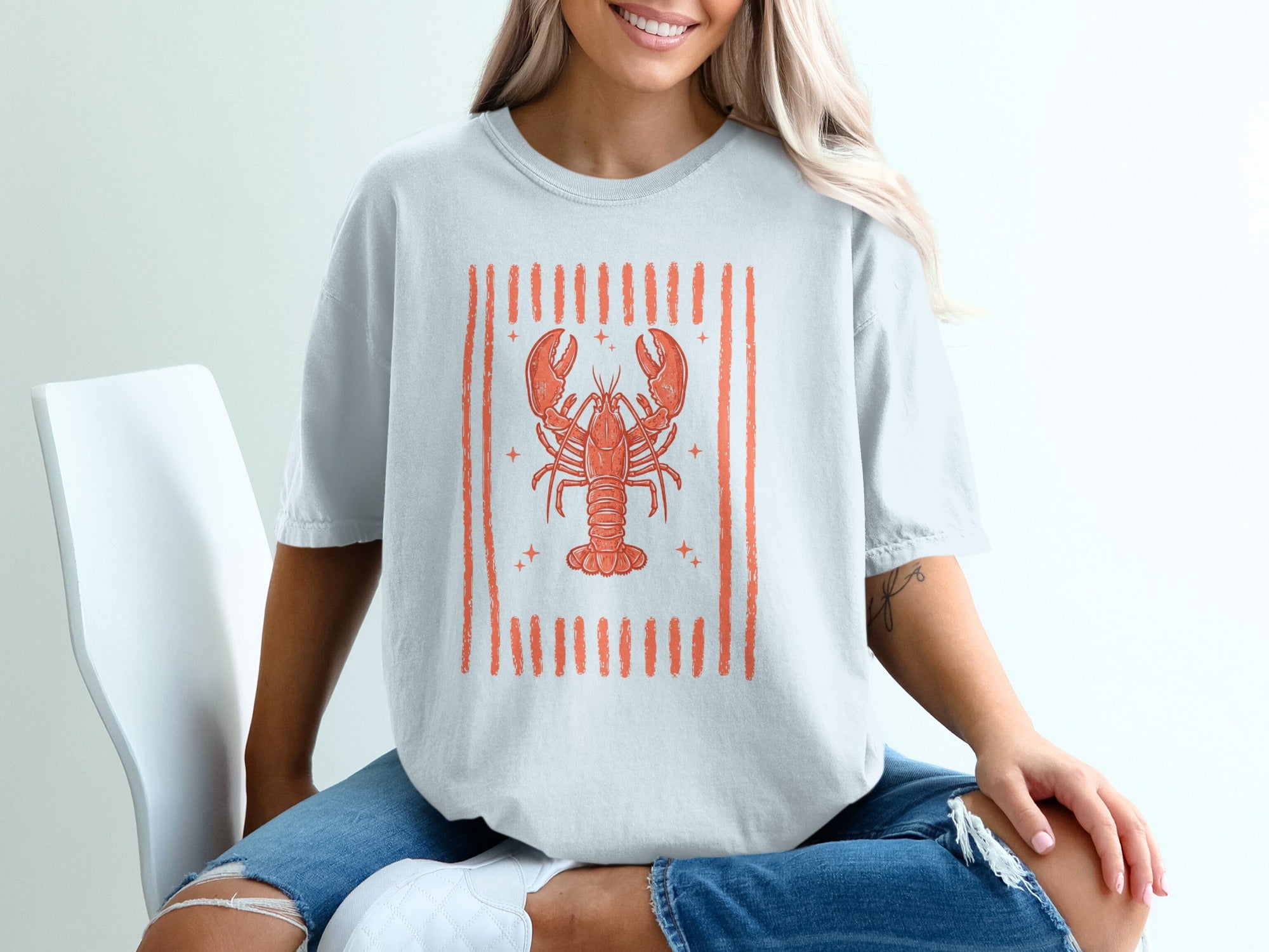 Light gray t-shirt with distressed orange lobster graphic and vertical stripes.