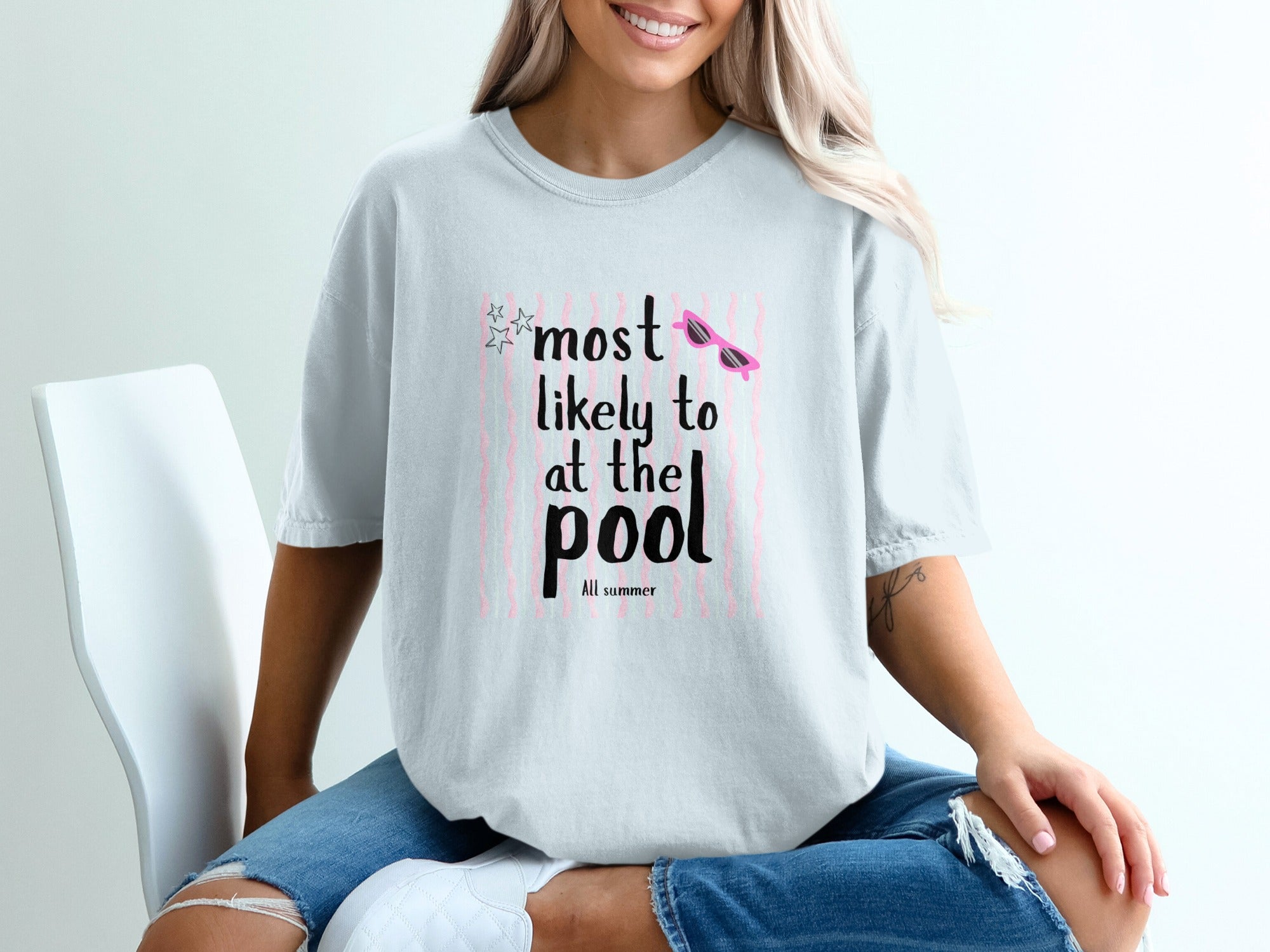 T-shirt with "most likely to at the pool all summer" text and pink sunglasses.
