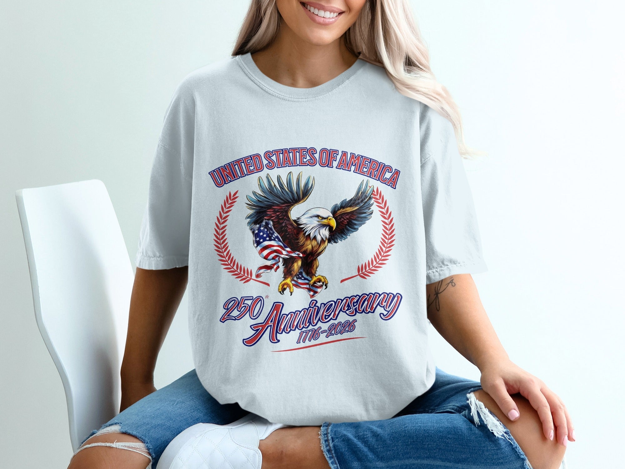 White t-shirt with eagle, flag, and "United States of America 1776-2025" text.