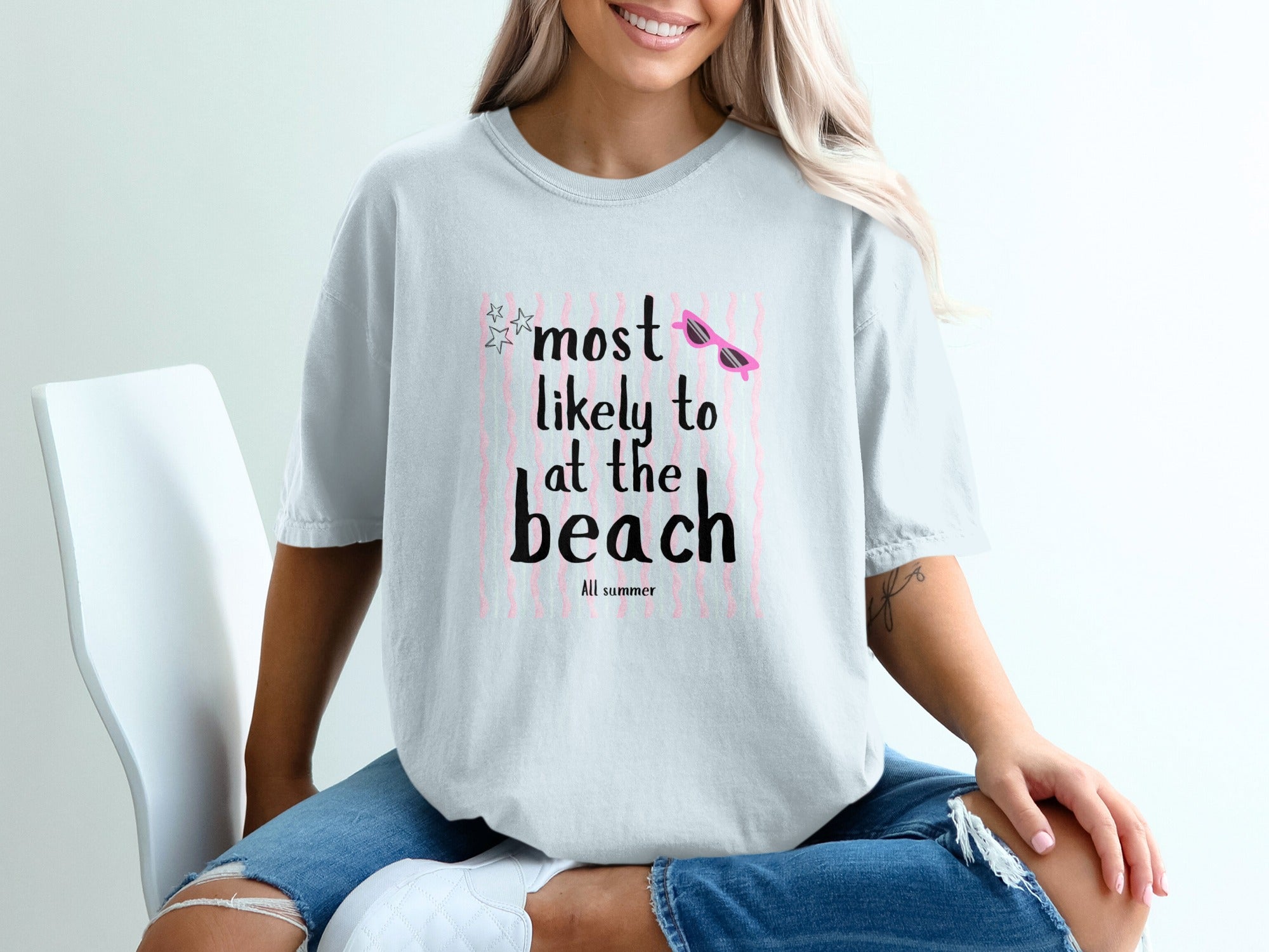 Light blue t-shirt with "Most Likely to at the Beach" text and sunglasses graphic.