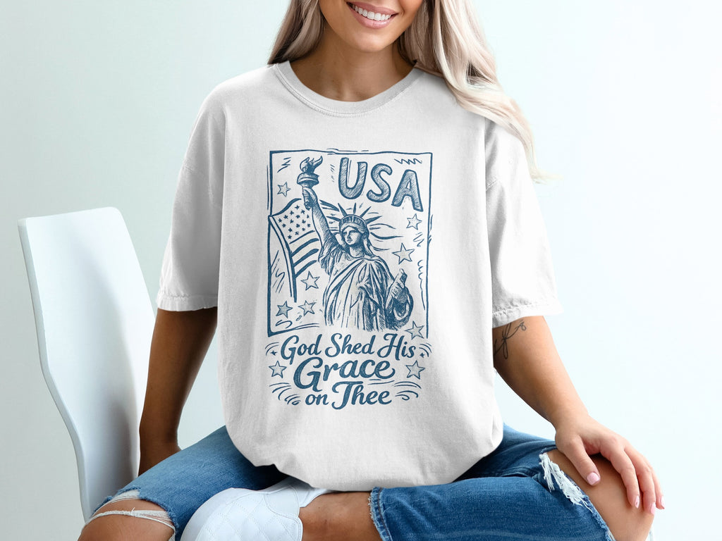 White t-shirt with Statue of Liberty and "USA God Shed His Grace on Thee" text.