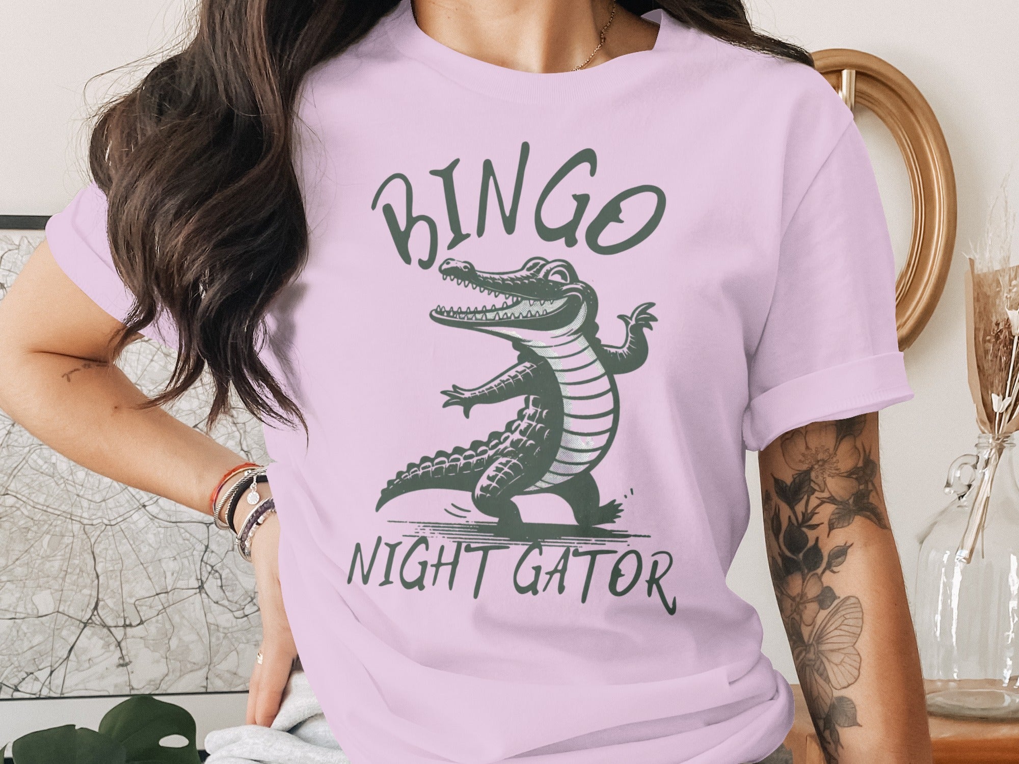 Pink t-shirt with a cartoon alligator and text "BINGO NIGHT GATOR".