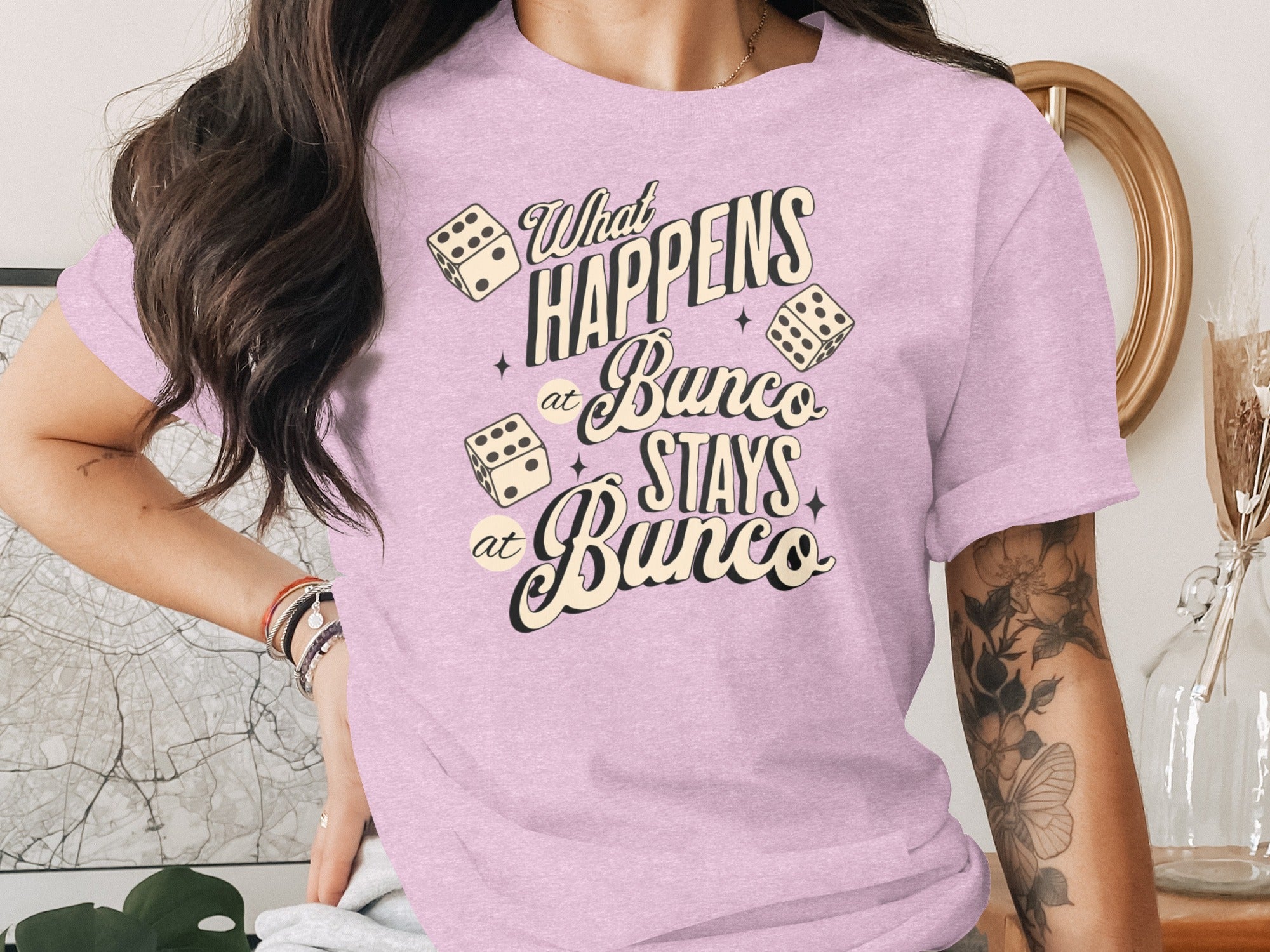 Pink t-shirt with "What HAPPENS at Bunco STAYS at Bunco" text and dice graphics.