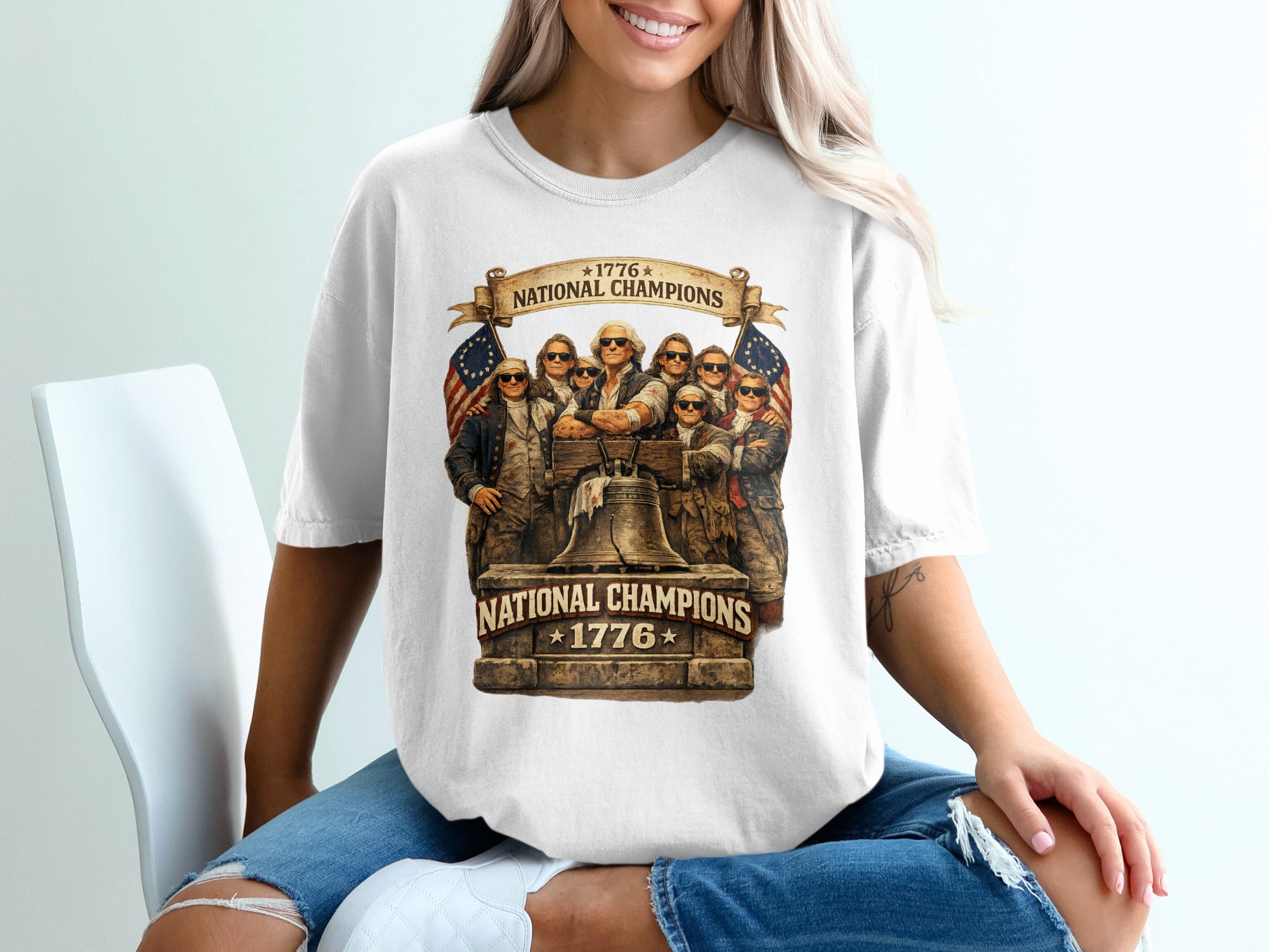 T-shirt graphic with 1776 National Champions text and eagle-eyed figures.