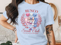 Bunco Social Club t-shirt graphic with dice, score card, and playful text.