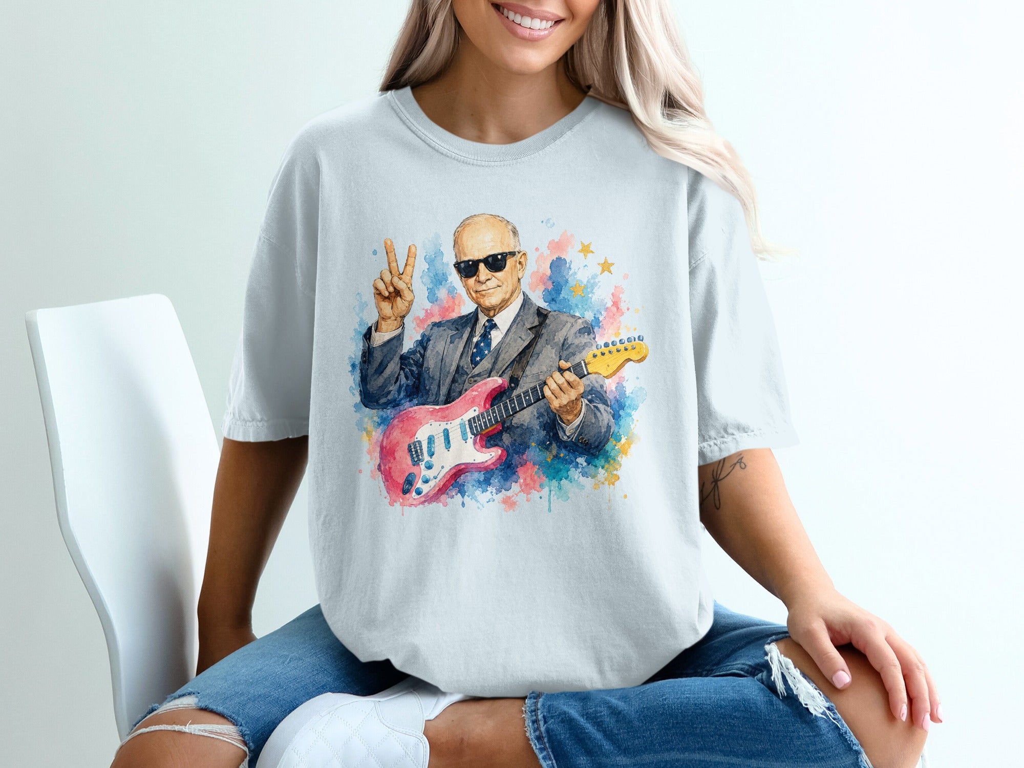 Man in suit with pink guitar and peace sign, watercolor splash effect.