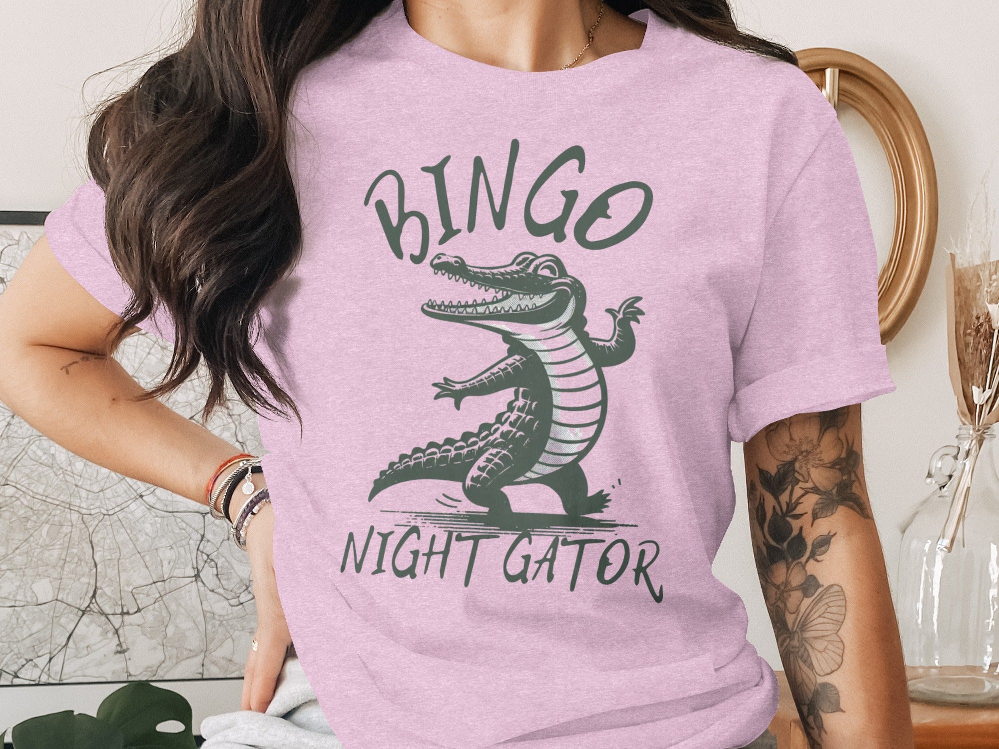 Pink t-shirt with green text "BINGO NIGHT GATOR" and a cartoon alligator.